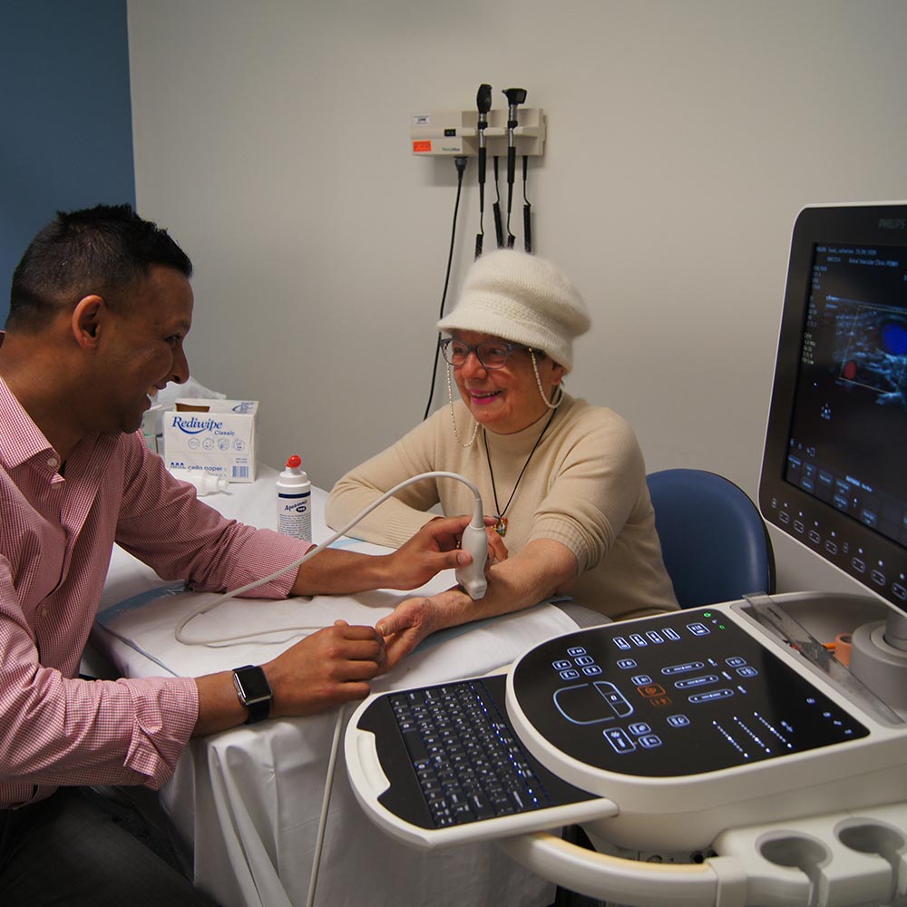 A doctor scanning the arm of an elderly patient