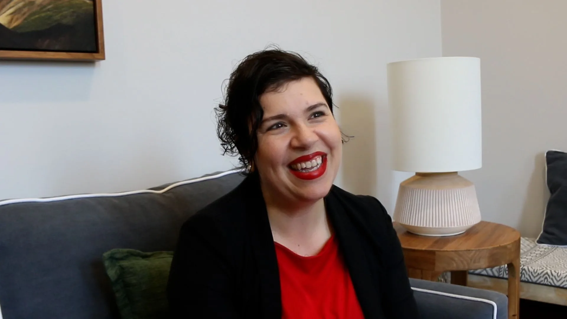 women sitting down for an interview wearing red blouse with black blazer